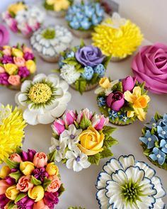 cupcakes decorated with colorful flowers on a table