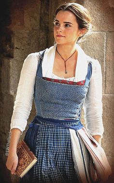 a woman wearing an apron and holding a book