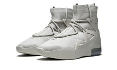 The Nike Air Fear of God 1 “Friends & Family” is a rare colorway given to those within the inner circle of Jerry Lorenzo's upscale streetwear brand.  Sporting a decidedly progressive appearance, the hybrid performance basketball and lifestyle shoe has been worn on-court by today’s NBA superstars and in city streets by style savants alike.  The upper features a premium Light Bone leather base that is contrasted by a staggered lacing system.  A tonal TPU support cage emits a technical component wh Modern High-top Sneakers For Light Sports With Vibram Sole, Modern High-top Sneakers With Vibram Sole For Light Sports, Nike Modern Mid-top Custom Sneakers, Modern Nike Mid-top Custom Sneakers, Modern Nike Custom Mid-top Sneakers, Nike Urban Custom Sneakers With Abzorb Midsole, Modern Nike Custom Sneakers With Boost Midsole, Nike Modern High-top Sneakers For Streetwear, Nike Leather High-top Sneakers For Light Sports