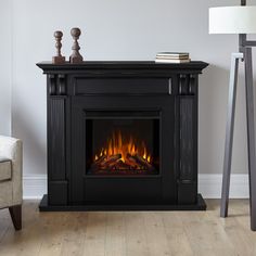 a living room with a fire place in the center and a chair next to it