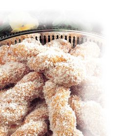 powdered sugar coated doughnuts in a basket