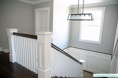 an empty staircase in a house with white railings and wood flooring on the side