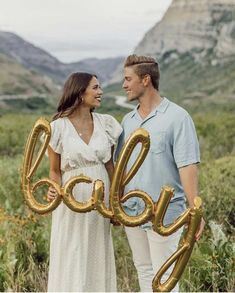 a man and woman are holding balloons in the shape of the word ocalay