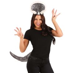 a woman wearing a cat costume and holding her hands up in the air while standing against a white background