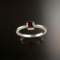 "This is a 4mm square Natural red Garnet. Bezel set in 14k white gold with cold-forged band that tapers from 1mm thick at the top to 2mm thick at the bottom. It's a very good design to stack. Specify your ring size in a \"note to seller\" at check-out." Classic Square Sterling Silver Rings, Emerald Cut Sterling Silver Stackable Rings For Formal Occasions, Modern 14k White Gold Stackable Rings As Gift, Formal Emerald Cut Sterling Silver Stackable Rings, Formal Stackable Ruby Ring In Sterling Silver, Classic Rectangular Stackable Rings, Mothers Ring Stackable, Square Stone Ring, Birthstone Ring Mothers