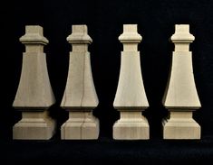 four pieces of wooden chess on a black background