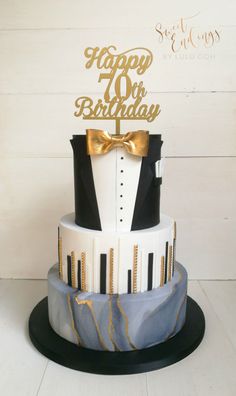 a birthday cake with a tuxedo and bow tie on it's top