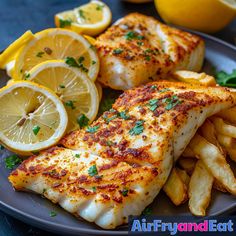 fish and french fries on a plate with lemons