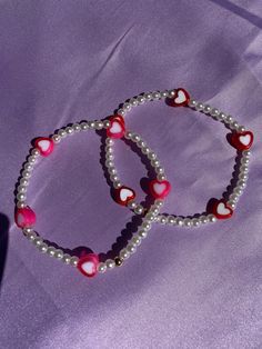 "Inspired by BTS' song \"Boy With Luv\". This bracelet is made of acrylic heart peads and 4 mm faux pearls. Take some love with you wherever you go with this dainty bracelet. Choose red or pink hearts." Valentine's Day Pearl Bracelet With Heart Charm, Valentine's Day Heart Charm Pearl Bracelet, Valentine's Day Heart Pearl Bracelet, Adjustable Pearl Heart Bracelet, Pearl Beaded Bracelets With Heart Beads, Pearl Bracelets With Heart Beads, Pearl Heart Bracelet For Valentine's Day Gift, Cute Beaded Heart Bracelet For Valentine's Day, Adjustable Pearl Heart Bracelet For Valentine's Day