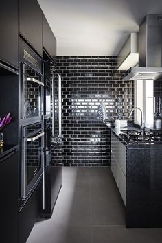 a black and white kitchen with stainless steel appliances