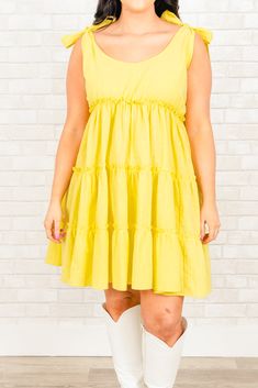 This dress is the perfect statement piece for any summer occasion! Featuring a bright honey color, a sassy length, and elegant shoulder ties, this dress is sure to turn heads! With its lightweight and airy fabric, you'll stay cool and confident all day! 100% Cotton Solid Color Sundress For Spring Day Out, Summer Sleeveless Knee-length Dress For Brunch, Sleeveless Sundress For Summer Brunch, Flowy Sundress Mini Dress, Flowy Sleeveless Dress For Spring Vacation, Solid Cotton Sundress For Spring, Chic Spring Sundress, Chic Solid Color Spring Sundress, Solid Cotton Mini Dress For Summer