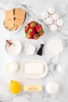 ingredients for strawberry shortcakes laid out on a marble counter top