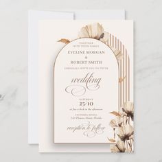 an elegant wedding card with flowers on the front and bottom, in gold foil lettering