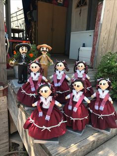 a group of dolls sitting on top of a wooden step