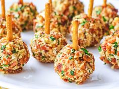 several appetizers are arranged on a plate with toothpicks sticking out of them