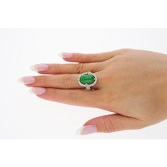 This is part of Chairish’s Fine Jewelry assortment.  Introducing a captivating 18K White Gold Ring, weighing 7.04 grams and adorned with a prong setting for timeless elegance. At the heart of this ring is a vibrant 7.29 carat cabochon-cut "A" grade Jadeite Jade, showcasing a rich green hue. Accentuating the Jade are 126 round-cut Diamonds, totaling 1.19 carats, delicately arranged to enhance the ring's overall brilliance.  Fixed with an intricate milgrain finish around the gemstones.   Item Deta Luxury Green Gemstones With Halo Setting, Luxury Green Oval Gemstones, Elegant Green Diamond Gemstones, Luxury Green Gemstones For Anniversary, Elegant Green Gemstones For Formal Occasions, Luxury Tsavorite Gemstones For Anniversary, Elegant Gia Certified Gemstones For Formal Occasions, Luxury Hallmarked Emerald Gemstones, Gia Certified Elegant Emerald Gemstones