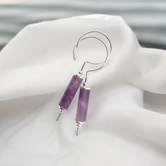 Elevate your style with Mystique - Silver & Amethyst Hook Threaders. These bold sterling silver earrings from our Mystique collection feature a stunning amethyst stone that adds a touch of daring to any outfit. Dare to stand out with these unique hook style threader earrings. Anti-tarnish Sterling Silver Approximately 1.5" in length Genuine Amethyst Gemstones Sent in a Ribboned Gift Box with Polishing Cloth Handmade in Montana Luxe Necklace, Threader Earrings Gold, Silver Threader Earrings, Luxe Jewelry, Studded Necklace, Threader Earrings, Modern Bohemian, Precious Jewelry, Amethyst Stone