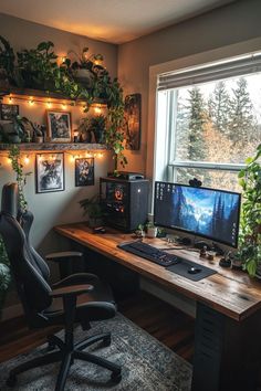 a desk with a computer on it in front of a window filled with potted plants