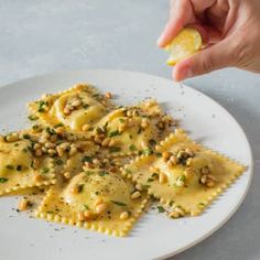 a person is picking up some food from a plate