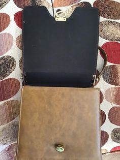 "Vintage 1960's 1970's Brown genuine Suede and Vinyl handbag. The handle is shorter and not able to put on the shoulder. Fully lined. Has an inside slip pocket as well as a zippered side pocket. (I have a pair of matching shoes listed in my shop. Please check if they are still available). *MORE INFORMATION BELOW* CONDITION: I note the inside zippered pocket has a tear in the lining. Difficult to photograph as the pocket is small. I also note a small wear area on the edge of the flap of the purse Retro Square Satchel For Office, Retro Business Shoulder Bag With Detachable Strap, Retro Business Crossbody Shoulder Bag, Vintage Office Satchel With Detachable Strap, Vintage Brown Box Bag With Removable Pouch, Vintage Shoulder Bag With Detachable Strap For Office, Retro Crossbody Shoulder Bag For Formal Occasions, Mid-century Brown Shoulder Bag For Travel, Vintage Tote Box Bag For Travel