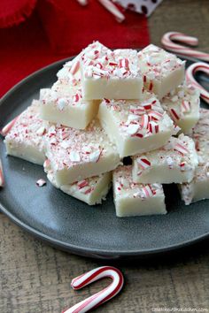 peppermint and white chocolate fudges on a plate with candy canes