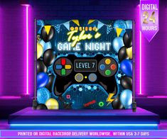 the game night stage with balloons and video game controllers on it's side, in front of purple neon lights