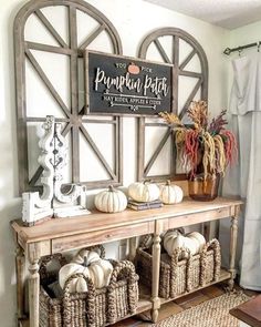 a wooden table topped with baskets filled with white pumpkins next to a sign that says pumpkin patch