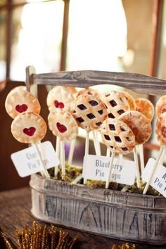 some pies are on sticks with blueberry toppings