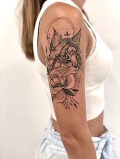 a woman with a cat tattoo on her arm and the other half of her arm