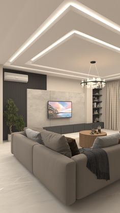 a modern living room with white walls and grey furniture, along with a flat screen tv mounted on the wall