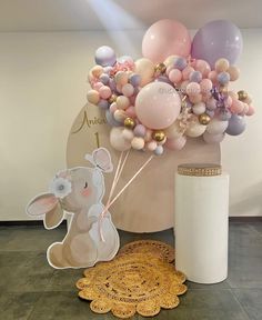 a balloon bouquet with an elephant and bunny cutout next to it