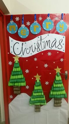 a door decorated with christmas trees and paper decorations for the front entrance to a school