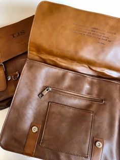 Our deluxe engravable briefcases make THE best guy gift for birthdays, graduation, groom gift, or just because! We can even tuck a quote from his favorite mentor on the inside. Briefcase has a shoulder strap, handle and spacious compartments. Pricing includes 3 initials on front and a quote of choice on inside. If no quote is provided, inside will be left blank. Faux leather briefcase with handle. High quality leather made to last. Briefcase Dimensions: 38cm/14.96inch(H) x 29cm/11.41inch(L) x 10 Classic School Briefcase, Classic Rectangular School Briefcase, Classic Rectangular Satchel As Gift, Brown Rectangular Satchel With Signature Hardware, Classic Laptop Bag As Gift, Leather Briefcase, Groom Gift, High Quality Leather, A Good Man