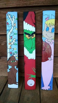 three painted wooden skis sitting on top of a wooden floor