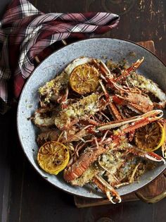 a plate full of cooked lobsters with lemon and pepper butter