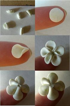 four different pictures of white flowers being made from clay and then placed on someone's finger