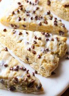 chocolate chip scones with icing on a white plate