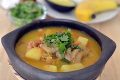 a bowl of soup with meat and vegetables