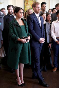 prince harry and his wife, the duke of cambridge are standing in front of a group of people