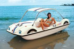 a woman sitting on top of a white boat in the ocean