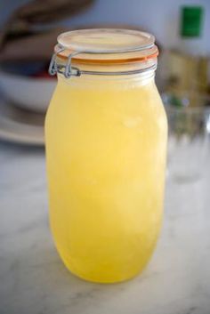 a glass jar filled with liquid sitting on top of a counter