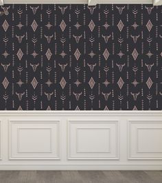 an empty room with black wallpaper and white paneled walls, decorated with decorative designs