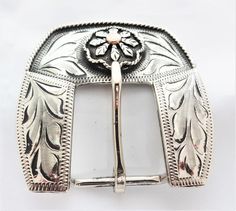 A new 3 piece buckle set from Hansen Western Gear. The set is made of Engraved antiqued sterling silver plate and includes matching buckle, keeper, and tip in the Sunrise Antique pattern.   Rope edged conchos with copper flower center.The measurements reflect the size of material that the buckle set will fit on to (the length measured from inner edge to inner edge).  For example, the 3/4" set will fit a 3/4" wide piece of material.Matching conchos avialable. Silver Concho Belt Buckles As Gift, Classic Silver Belt Buckles As Gift, Classic Silver Belt Buckle As Gift, Adjustable Engraved Silver Belt Buckles, Classic Silver Adjustable Belt Buckles, Classic Adjustable Silver Belt Buckles, Adjustable Antique Silver Belt Buckles, Antique Pattern, Western Horse Tack