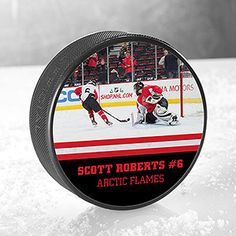 a hockey puck with the name scott roberts 6 on it and an image of two players playing