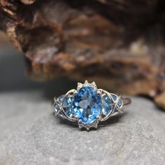 a blue ring sitting on top of a rock