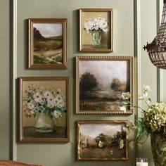 a bunch of pictures hanging on the wall with flowers in vases next to them