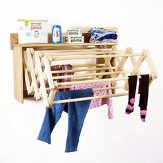 a clothes rack with baby's clothing hanging on it and two pairs of socks