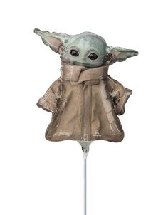 the child yoda toy is sitting on top of a stick