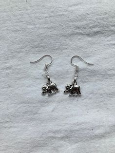 Silver Mini Elephant Earrings. Please see the second picture for the size reference. Any questions don't hesitate to drop me a message. Everyday Nickel-free Silver Plug Earrings, Small Silver Everyday Earrings, Small Silver Earrings For Everyday, Silver Dangle Plug Earrings, Silver Dangle Plug Earrings For Everyday, Silver Dangle Plug Earrings For Gifts, Elephant Earrings, Spirit Animal, Jewelry Earrings Dangle