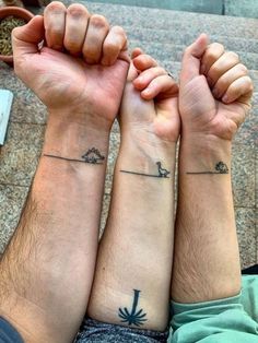 two people with matching tattoos on their arms